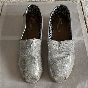 Tom’s women’s silver glitter slip ons. Size 9